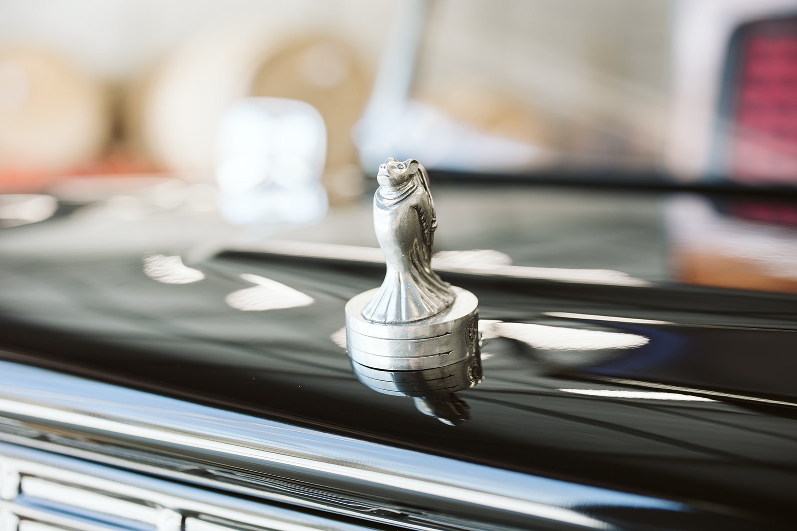 Chrome hood ornament detail on gloss black paint