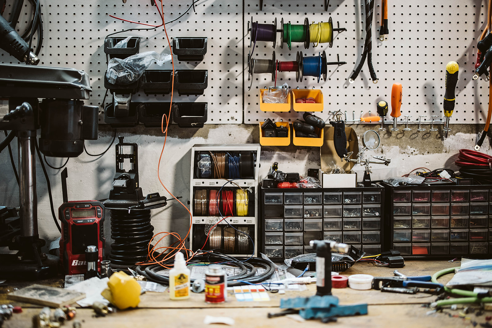 Workshop pegboard with tools and electronics
