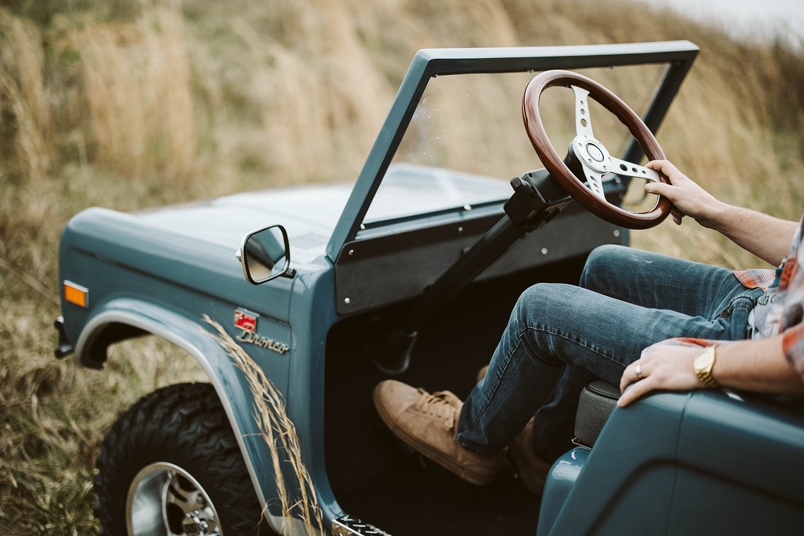 Lifestyle shot — driver behind the wheel on open terrain