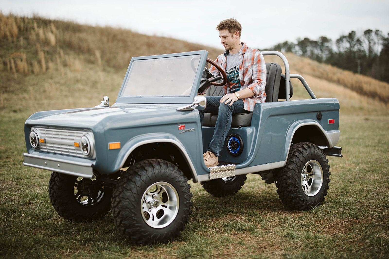Founder with Retro Ride in open field, lifestyle shot