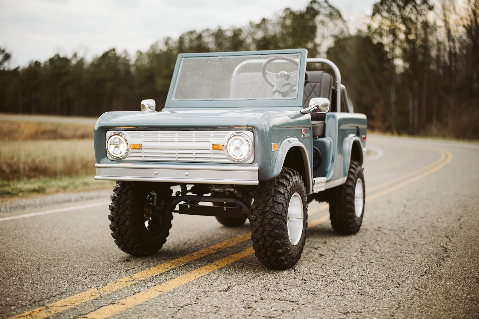 Vintage-styled Retro Ride on open road — driver-side 3/4 front view