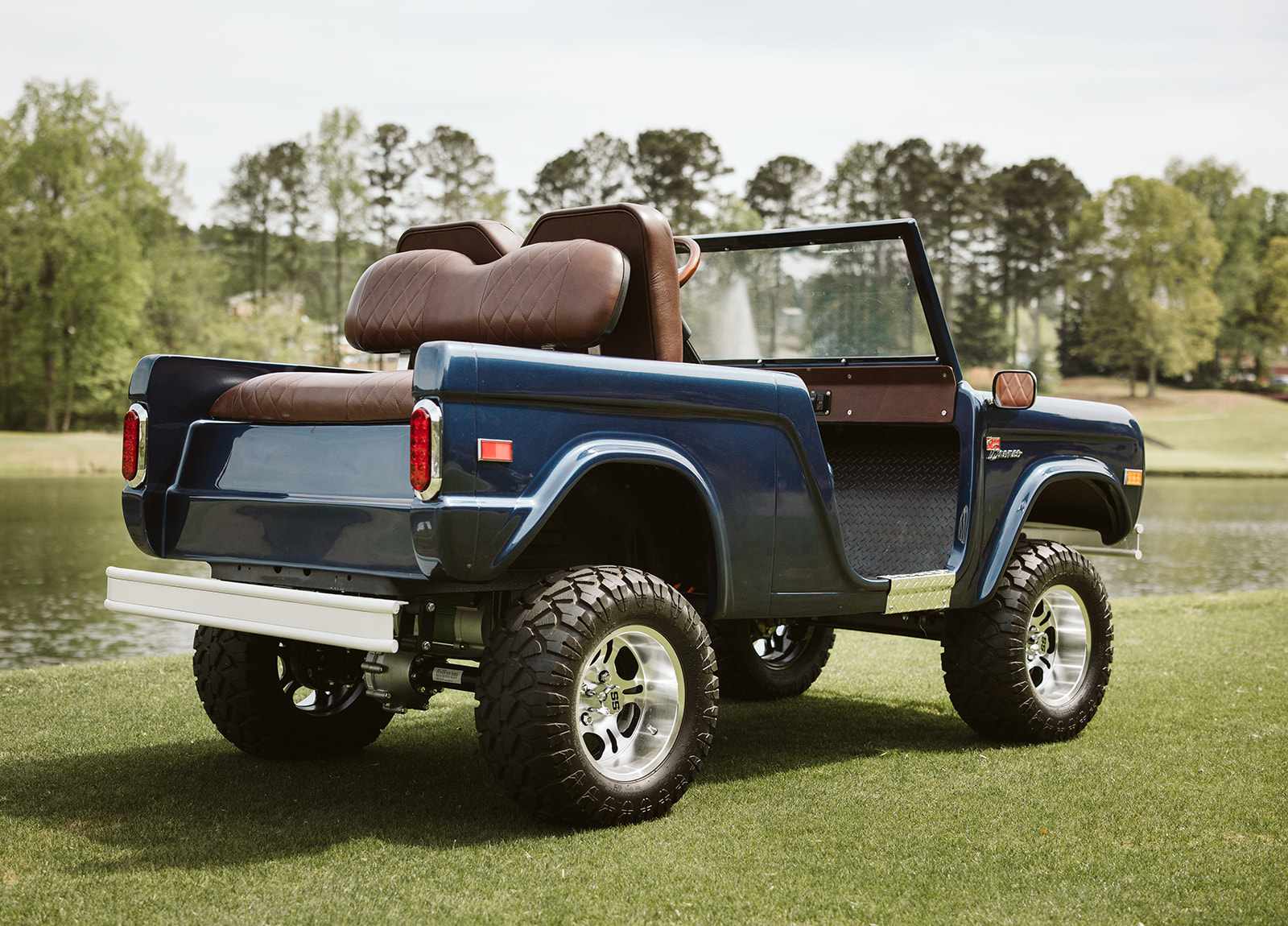 Retro Ride 6-Passenger, navy with brown leather, rear 3/4 view on golf course